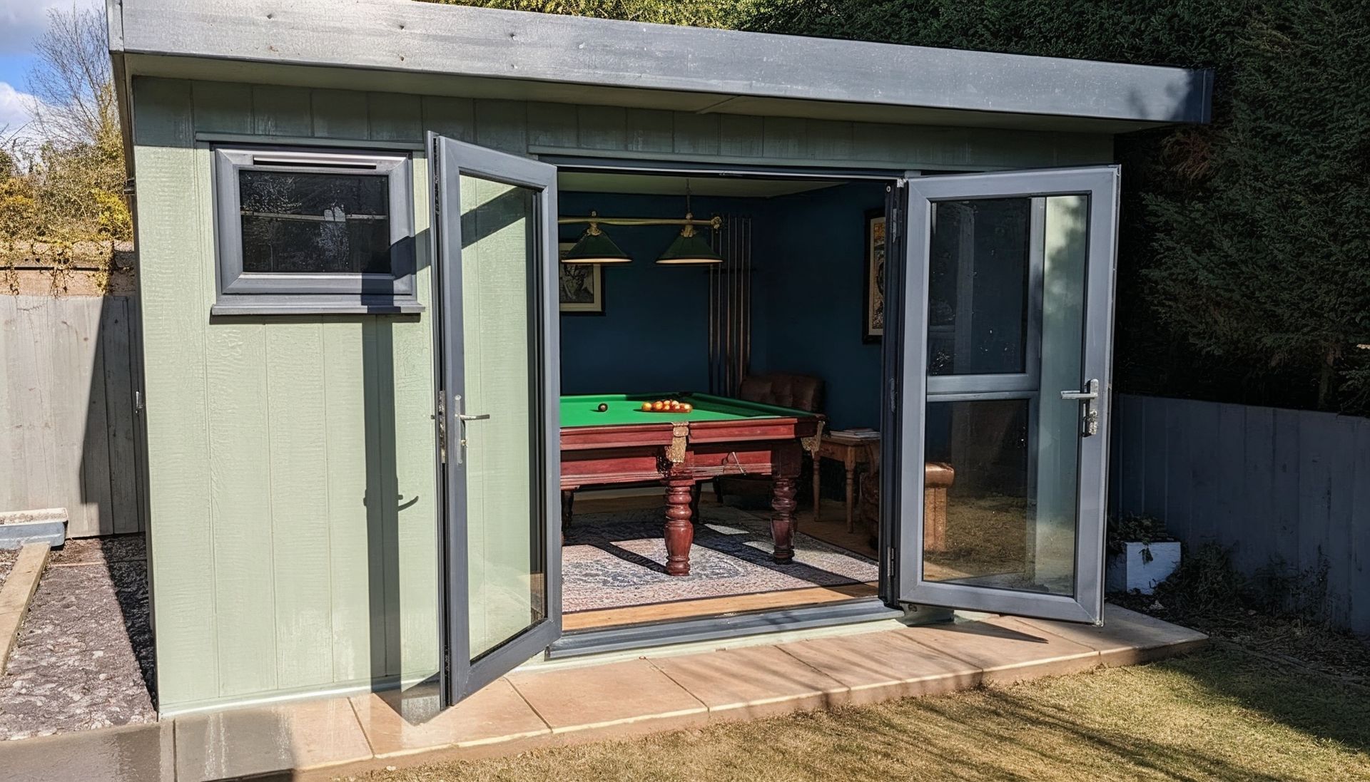 A garden building set up as a TV and games room