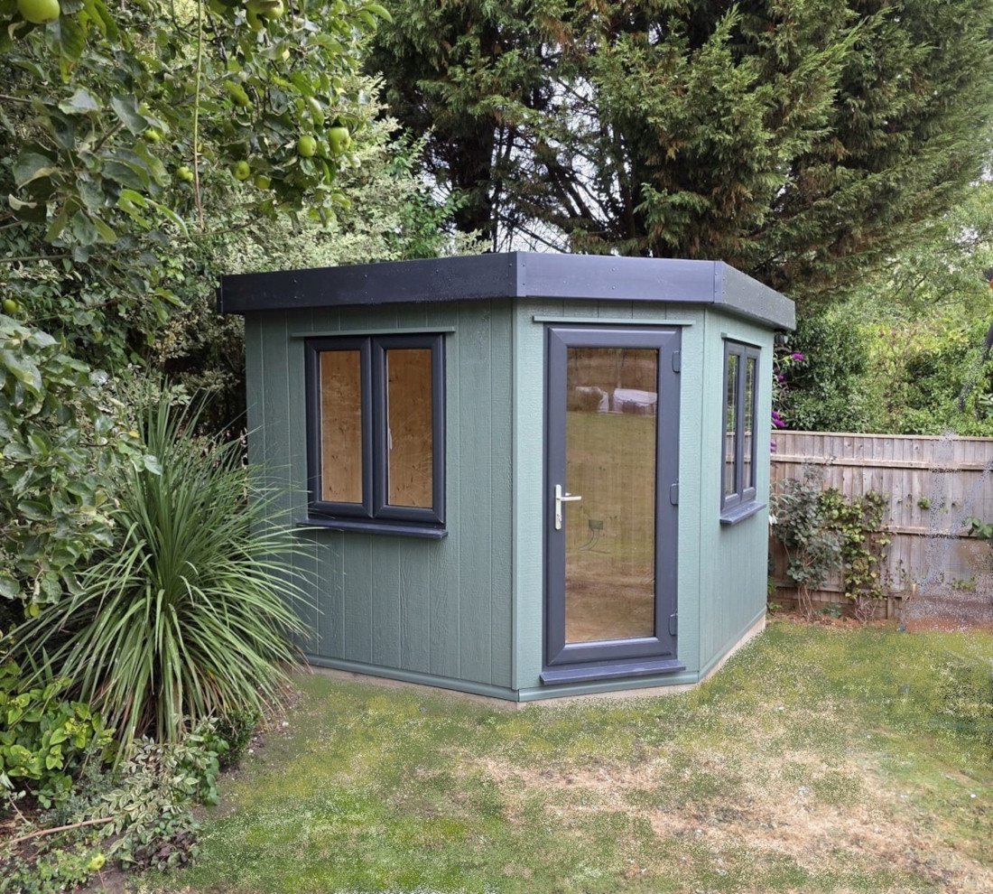 Cambridge Corner Studio Plus 9ft x 9ft (2.7m x 2.7m) with low maintenance painted board and grey uPVC windows, door and roof trims.