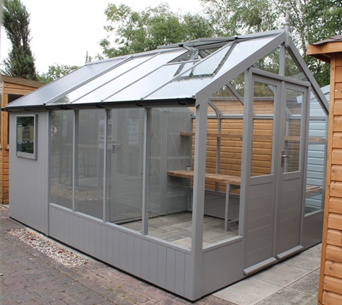 <strong>RAVEN:</strong> An 8ft 9in wide (2660mm) model with toughened safety glass. Locking hinged door. Various lengths available from 6'4 (1920mm) to 20’10 (6360mm). Various finishes & options. Pictured is an 8ft 9in x 12ft 7in Raven in Purbeck Stone with high level shelf, gutter system and combi shed.