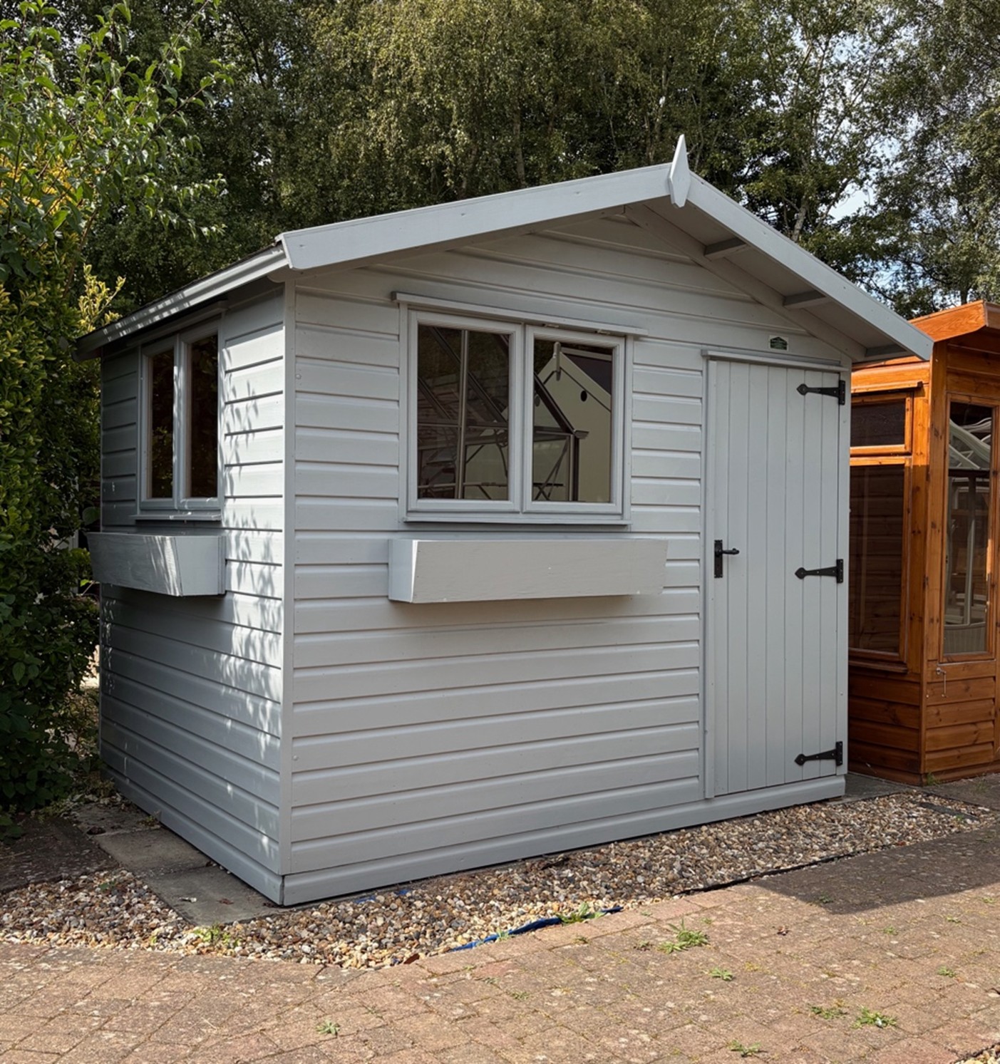 Norfolk Chalet 9ft x 7ft (2.7m x 2.1m) with optional window boxes and grey paint finish.