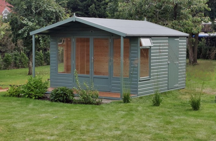 Newmarket Summerhouse 12ft x 8ft (3.6m x 2.4m) with 4ft (1.2m) shed and a veranda in mid-green paint finish.