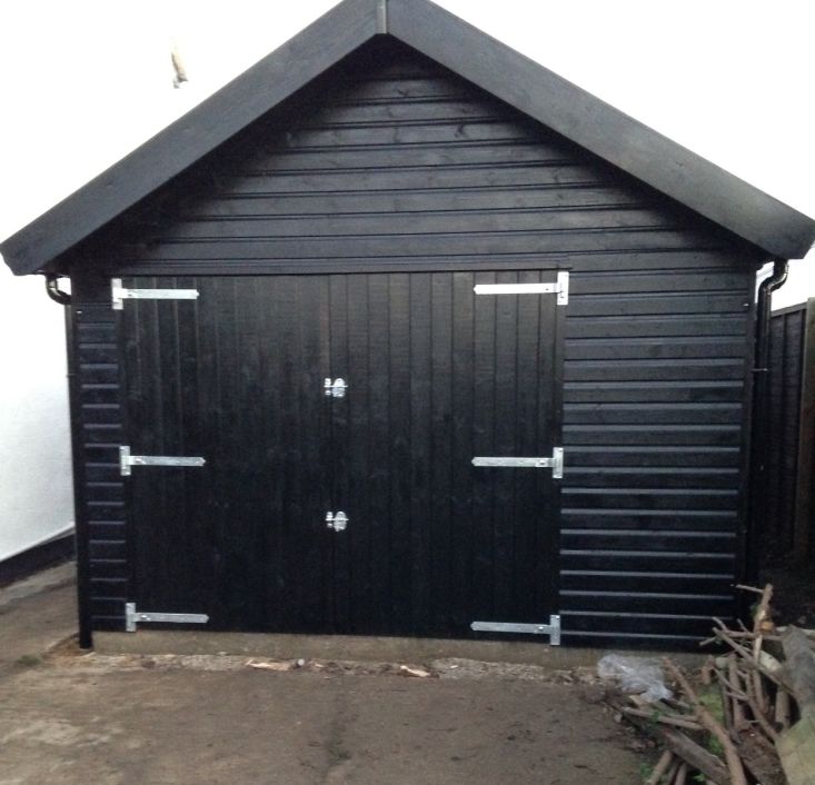 Classic wide single garage with offset double doors in black Sadolin finish