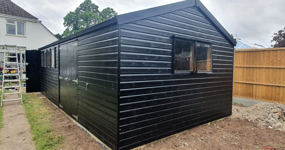 12ft x 24ft (3.6m x 7.2m) Craftsman Garage in black Sadolin wood stain with red felt tiles and an additional set of double doors.