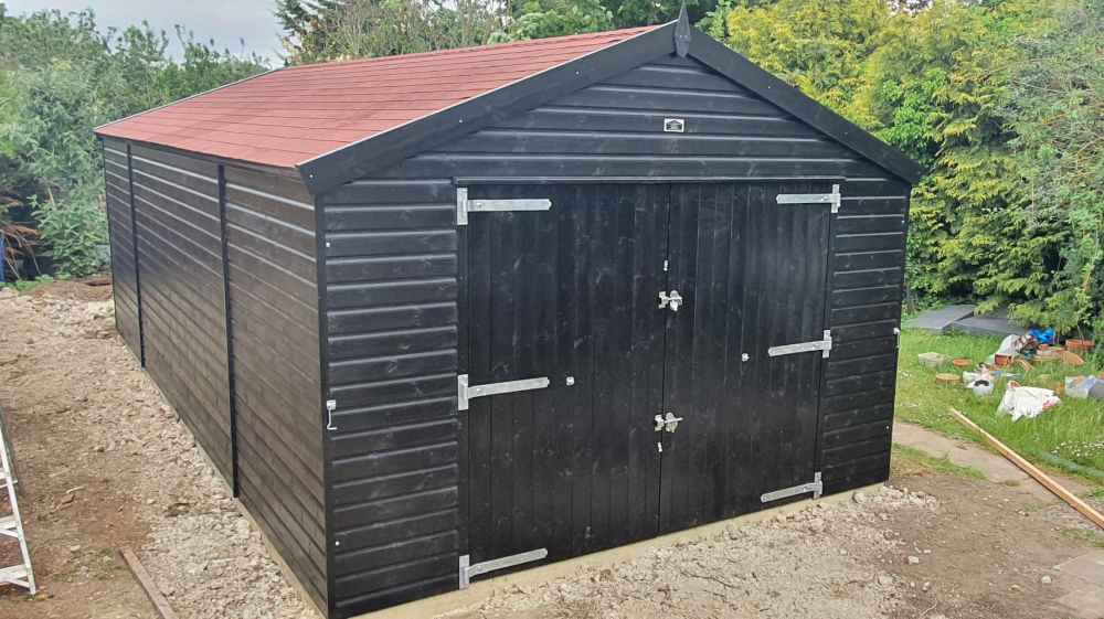 12ft x 24ft (3.6m x 7.2m) Craftsman Garage in black Sadolin wood stain with red felt tiles and an additional set of double doors.